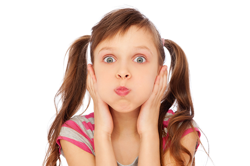 young girl making faces