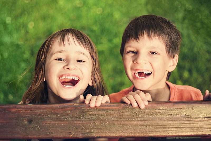 happy boy and girl playing outside