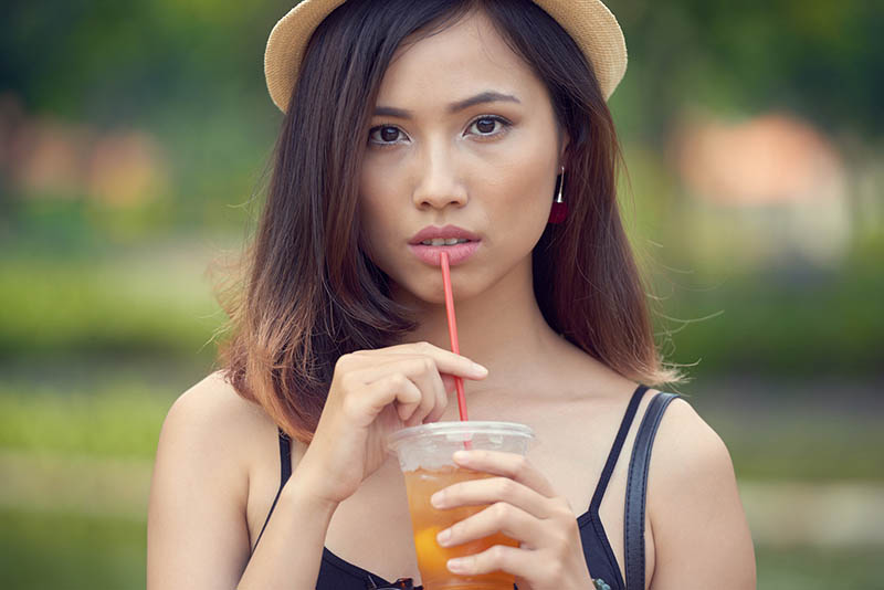 woman sipping iced tea