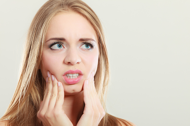 young woman with tooth pain